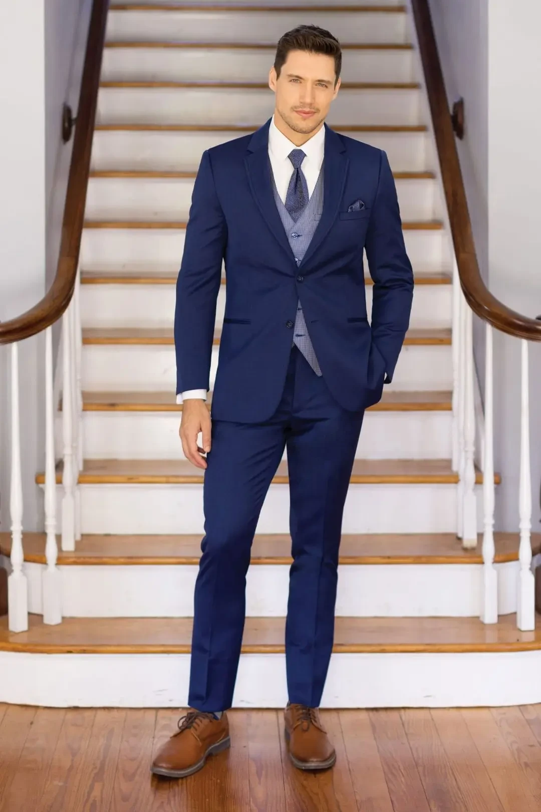 model is wearing a blue suit from jims formal wear