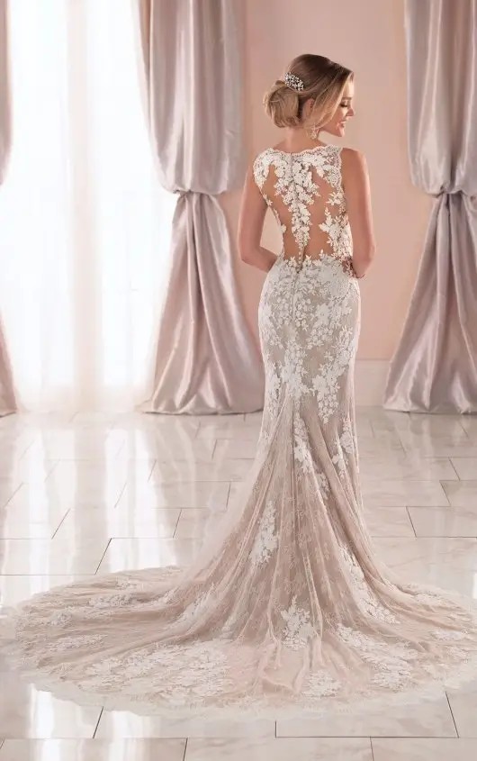 Model is wearing a sleeveless fitted lace bridal gown by stella york