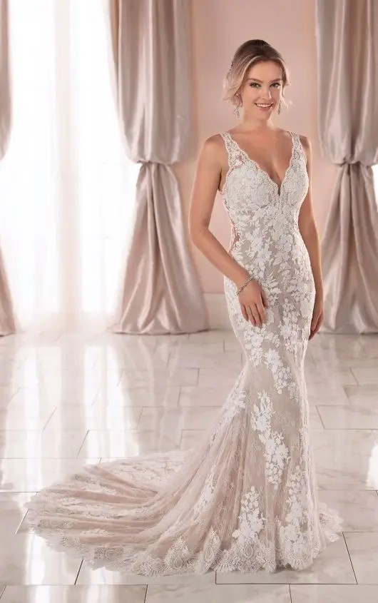 Model is wearing a sleeveless fitted lace bridal gown by stella york