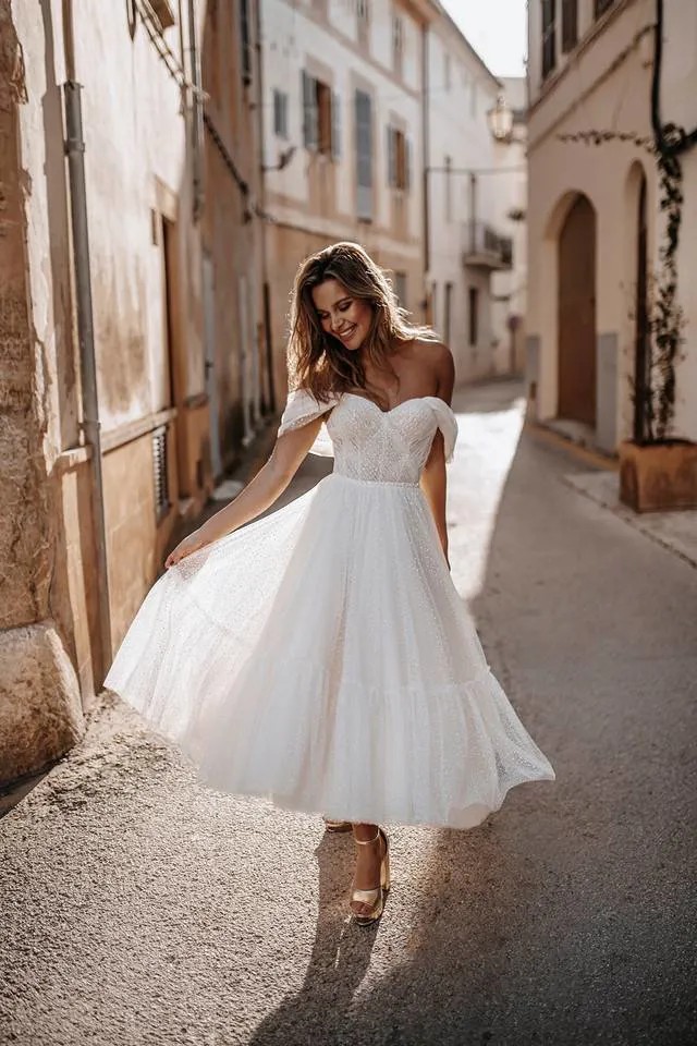 Model wearing white dress