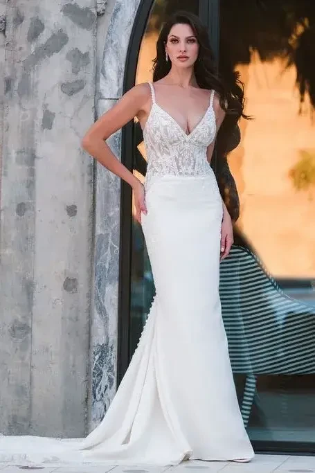 model is wearing a sleeveless open back bridal gown