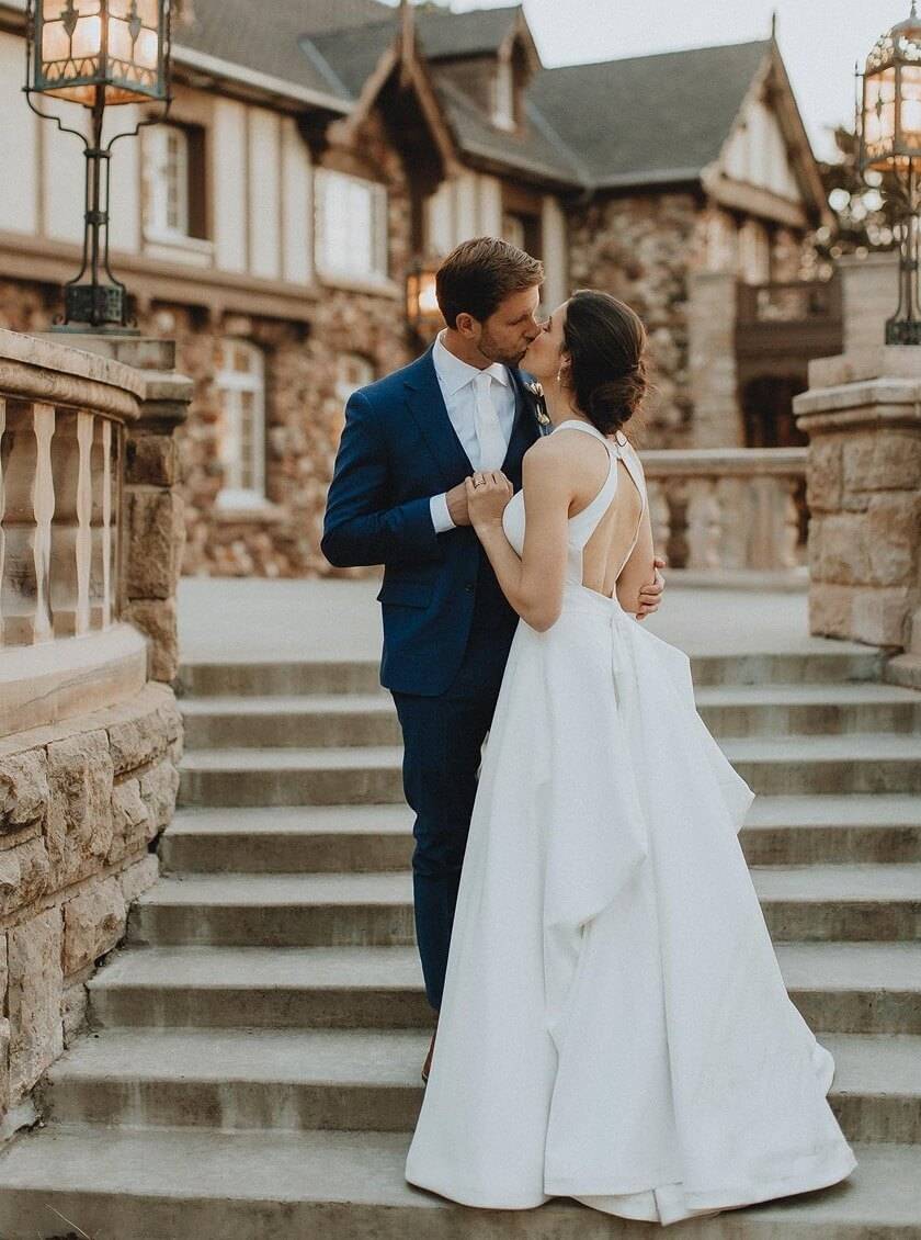 Сouple wearing a white gown and a black suit